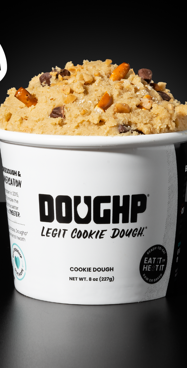 Close shot of Naughty & Nice cookie dough flavor from Doughp displaying pretzels, chocolate chip, and caramel pieces in the dough